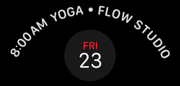 A line of white text that appears to follow the curve of the upper third of a circle. The text reads 8:00 AM yoga, flow studio. Centered below the text is the calendar date friday twenty-three displayed in a circular area.